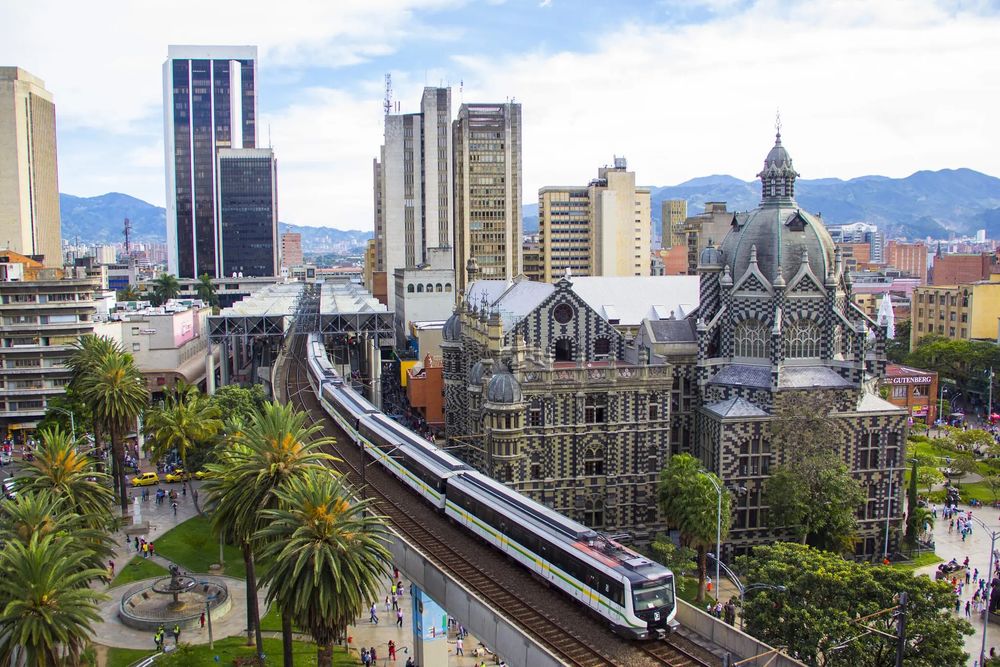 This features the city live in Medellin, Colombia by showing the tall building, with the metro right in the middle of the picture with an architectual building to the right. This picture shows the mix of modern and historical as well as adding greenery to really set the vibe and make it an overall more pleasing view